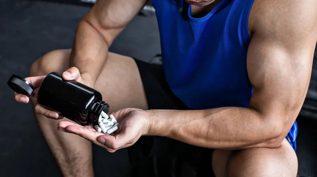 Man Taking White Sarms Caps Without Label At Gym. 