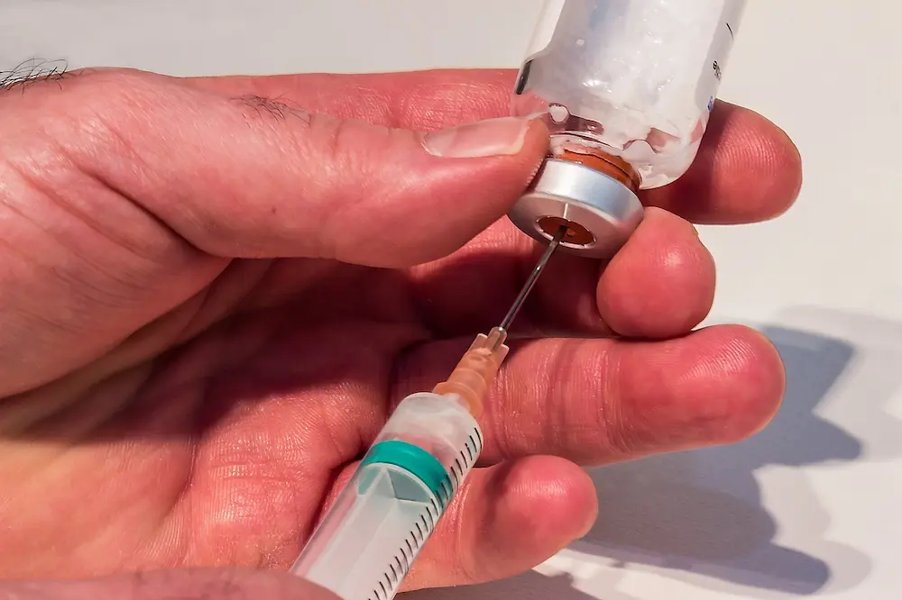 Man Drawing Testosterone Enanthate Ready Solution Via Needle And Syringe 